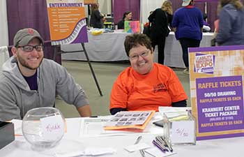 two volunteers sitting at a desk